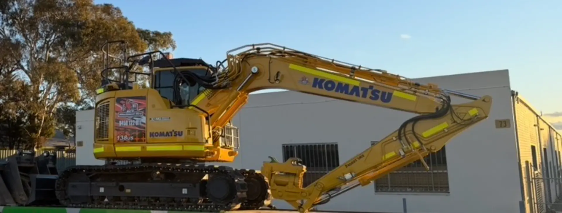 Yellow excavator parked in the yard