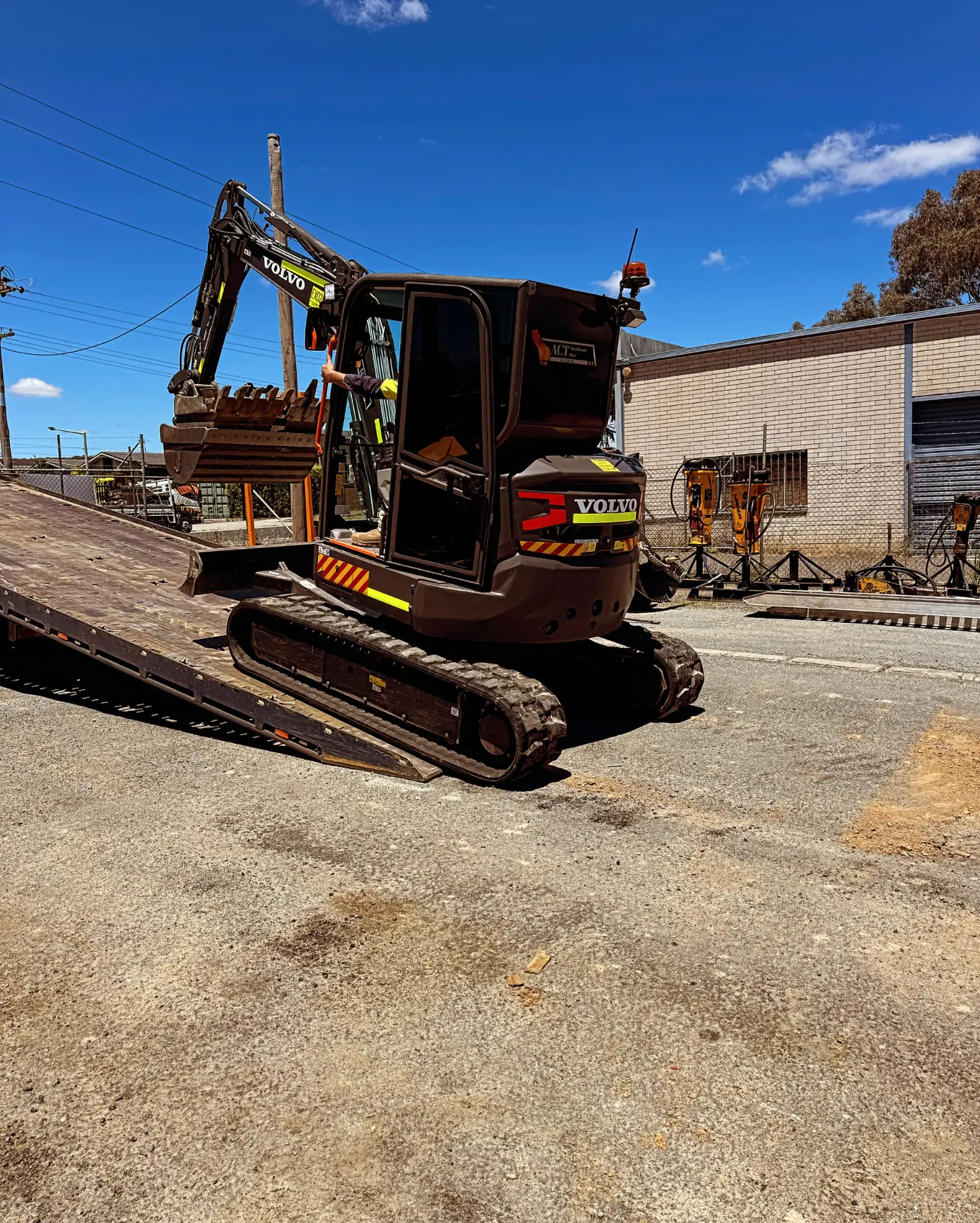 Excavator on the concrete yard apron