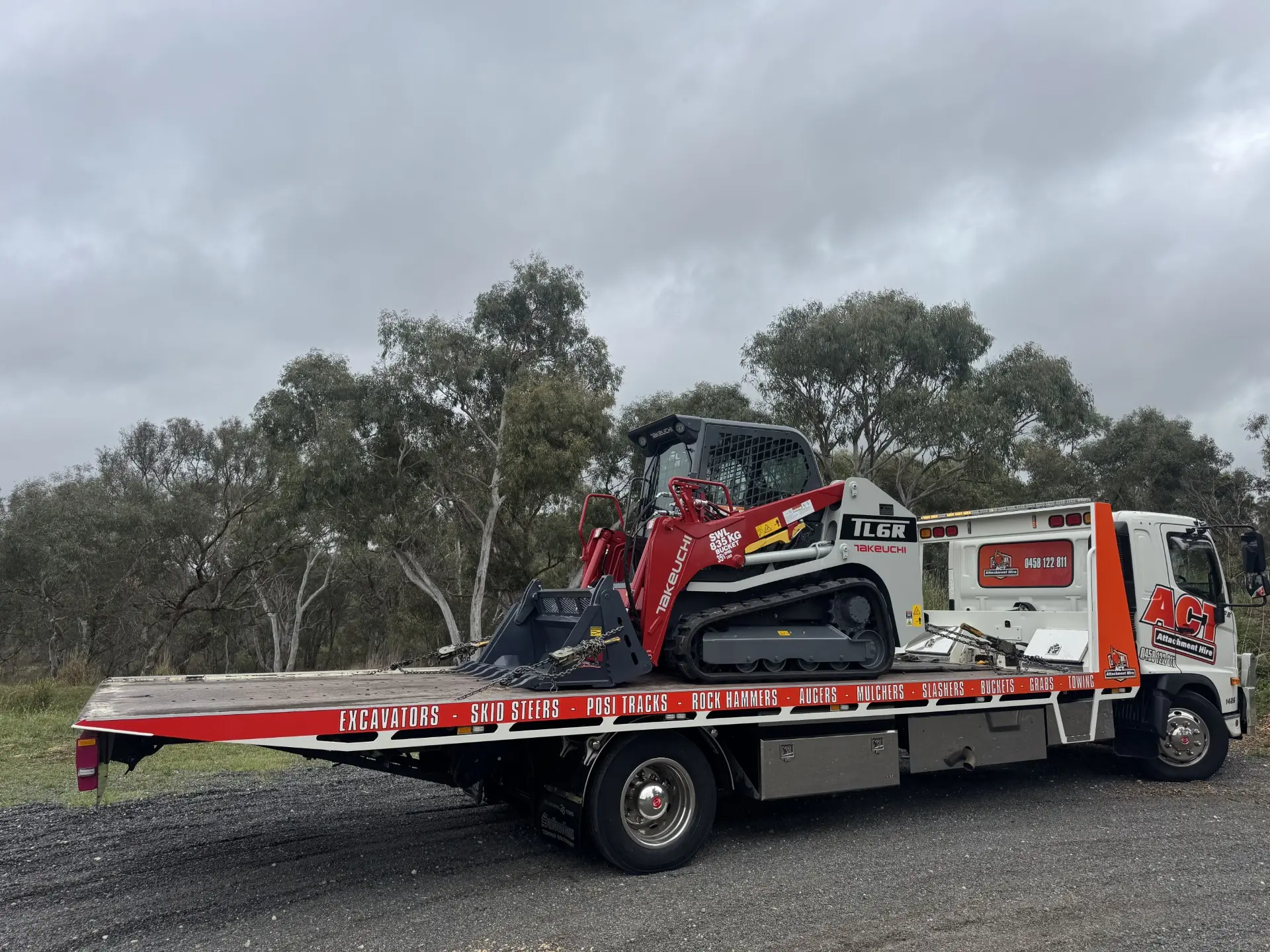 Skid steer loaded on the flatbed for delivery
