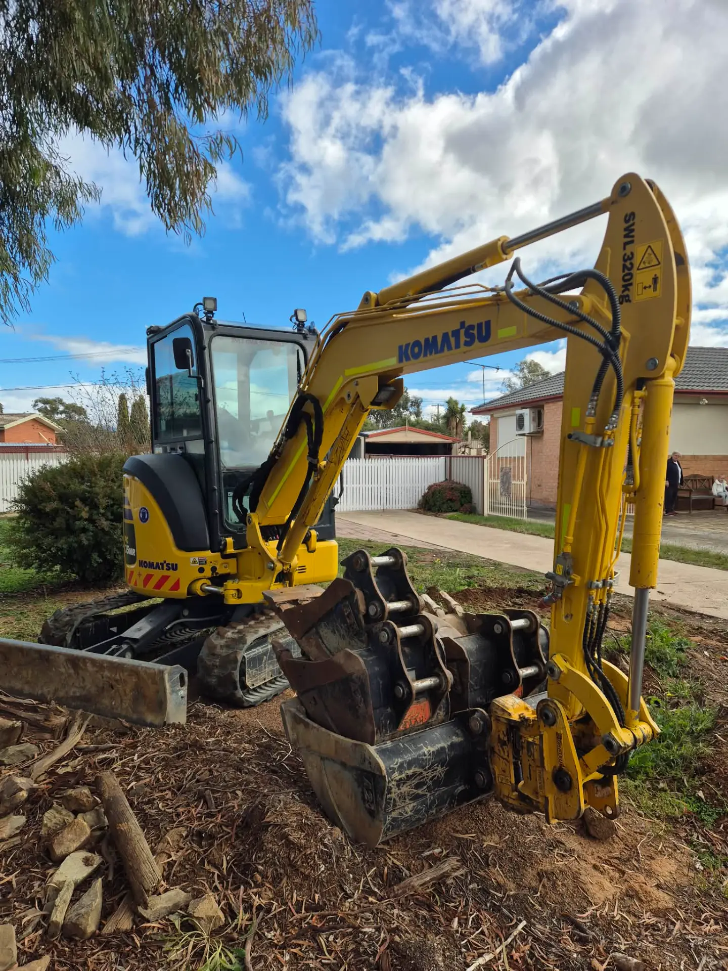 Mini excavator digging in a residential backyard