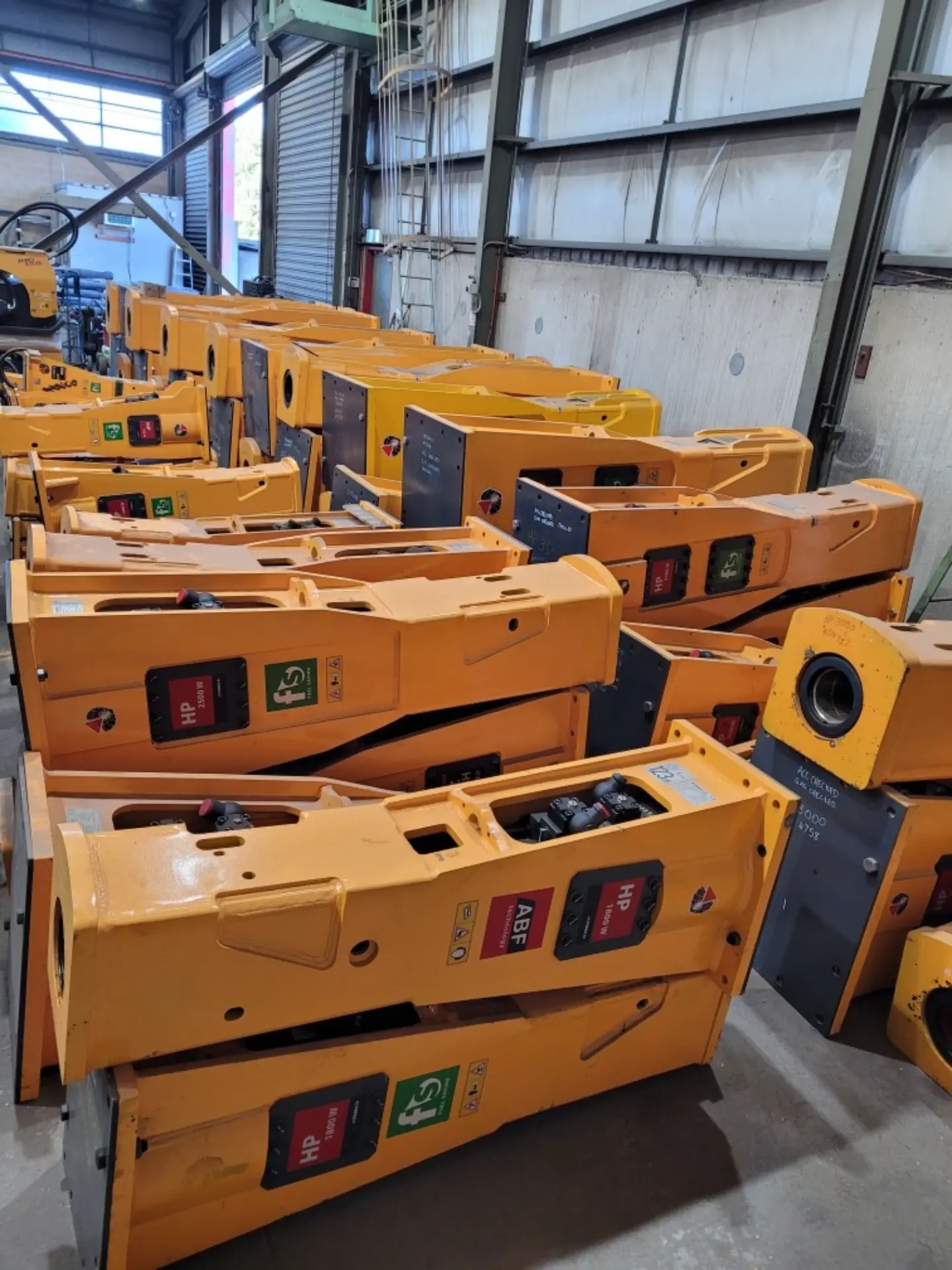 Hydraulic hammers in a range of sizes stored at the hire yard