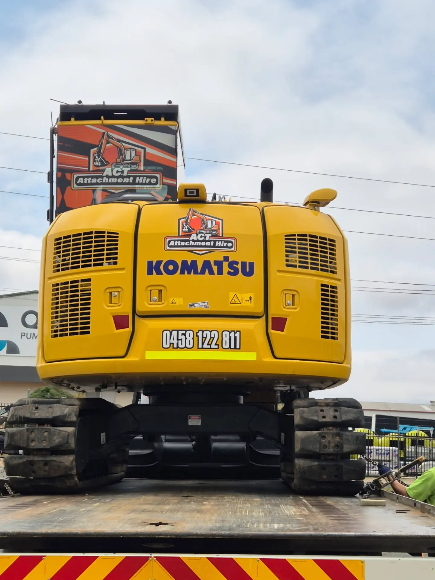 Close-up of an excavator front grille and branding stripe