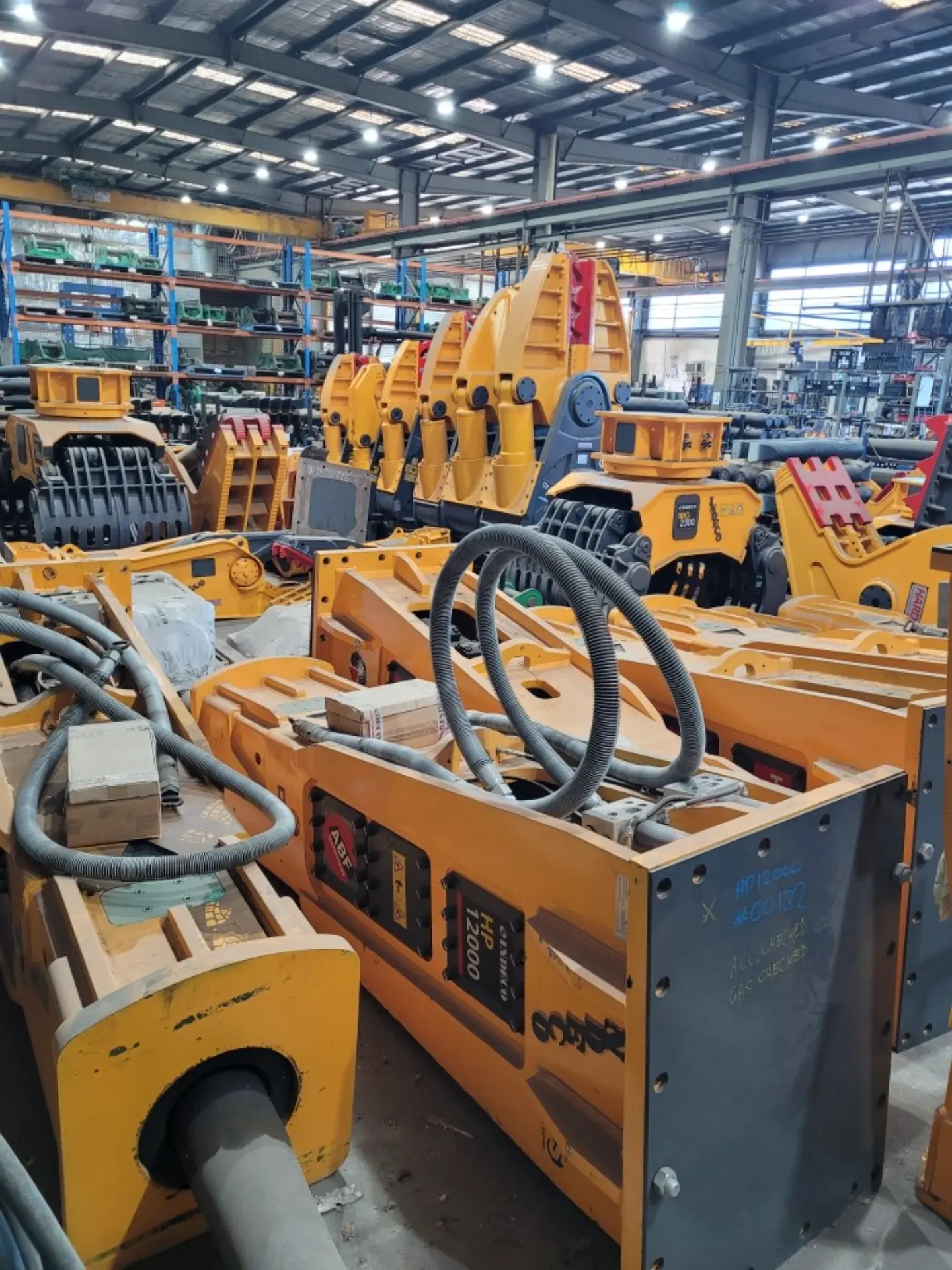 Hydraulic hammers in stock on warehouse shelving