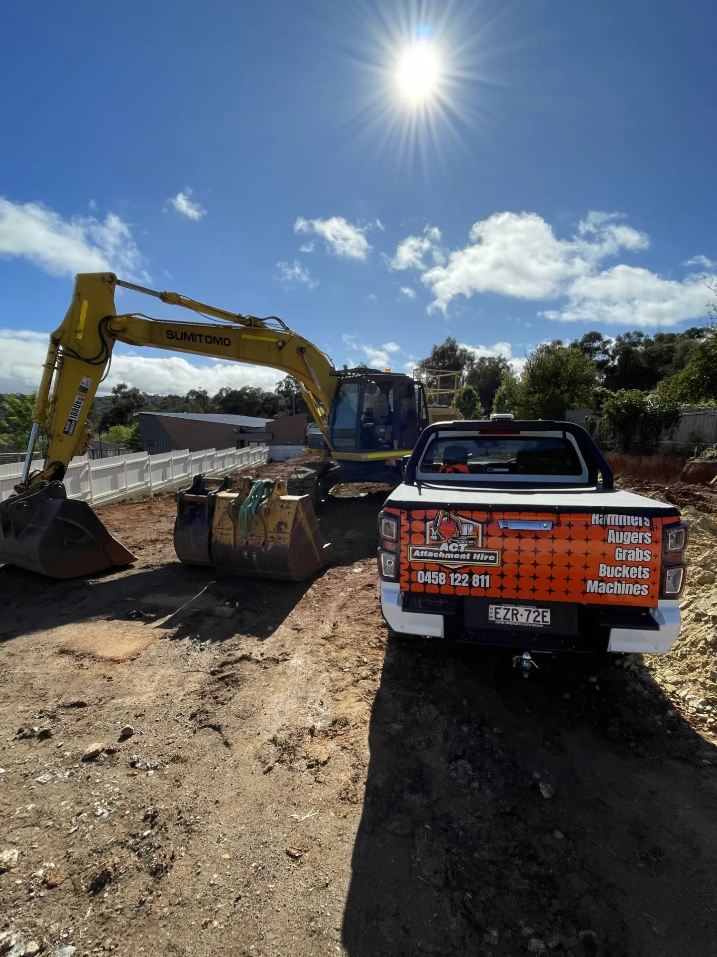 Excavator loading a dump truck on a paddock block