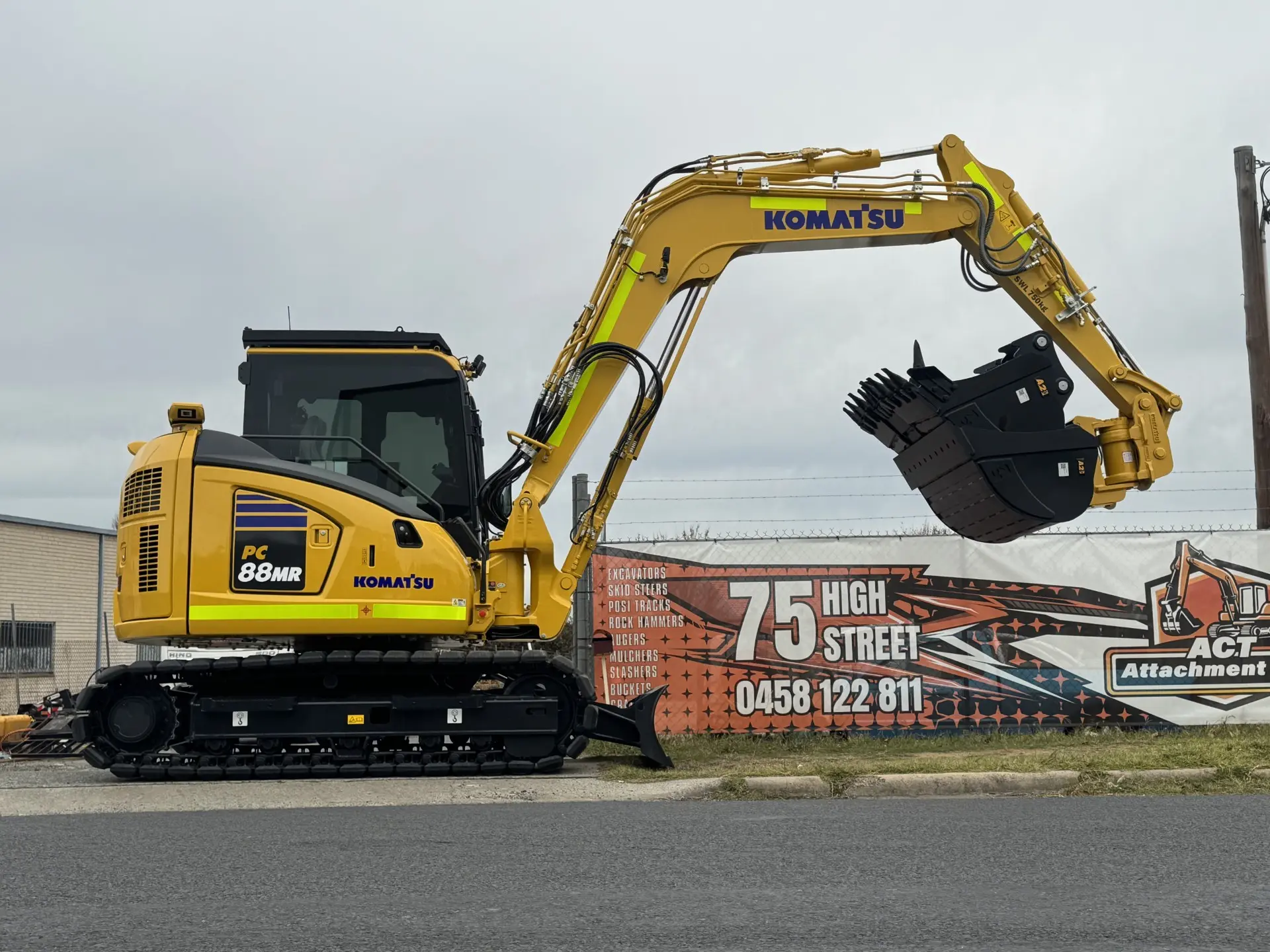 Excavator with a grapple thumb attachment at the Queanbeyan East yard
